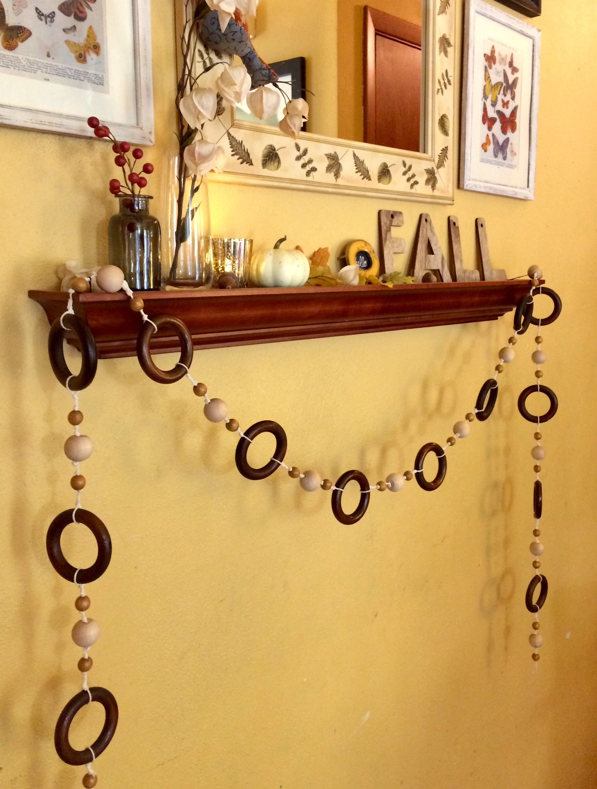 Handmade wood bead garland with vintage wooden curtain rings for fall or autumn decorating on mantel or shelf